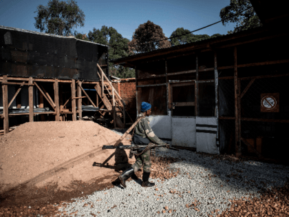 A soldier from the Armed Forces of the Democratic Republic of the Congo (FARDC) patrols inside an Ebola Treatment Centre (ETC) in Butembo, the epicentre of DR Congo's latest Ebola outbreak, after it was attacked on March 9, 2019. - Mai-Mai rebels attacked the ETC in the early hours of …