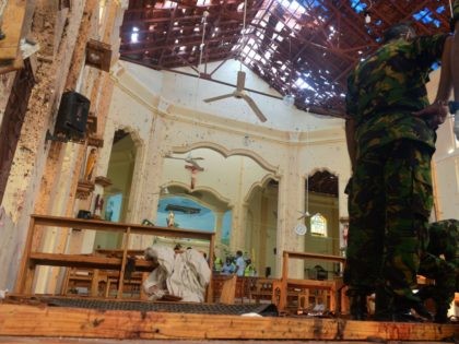Security personnel inspect the interior of St. Sebastian's Church in Negombo on April 22, 2019, a day after the church was hit in series of bomb blasts targeting churches and luxury hotels in Sri Lanka. - The death toll from bomb blasts that ripped through churches and luxury hotels in …