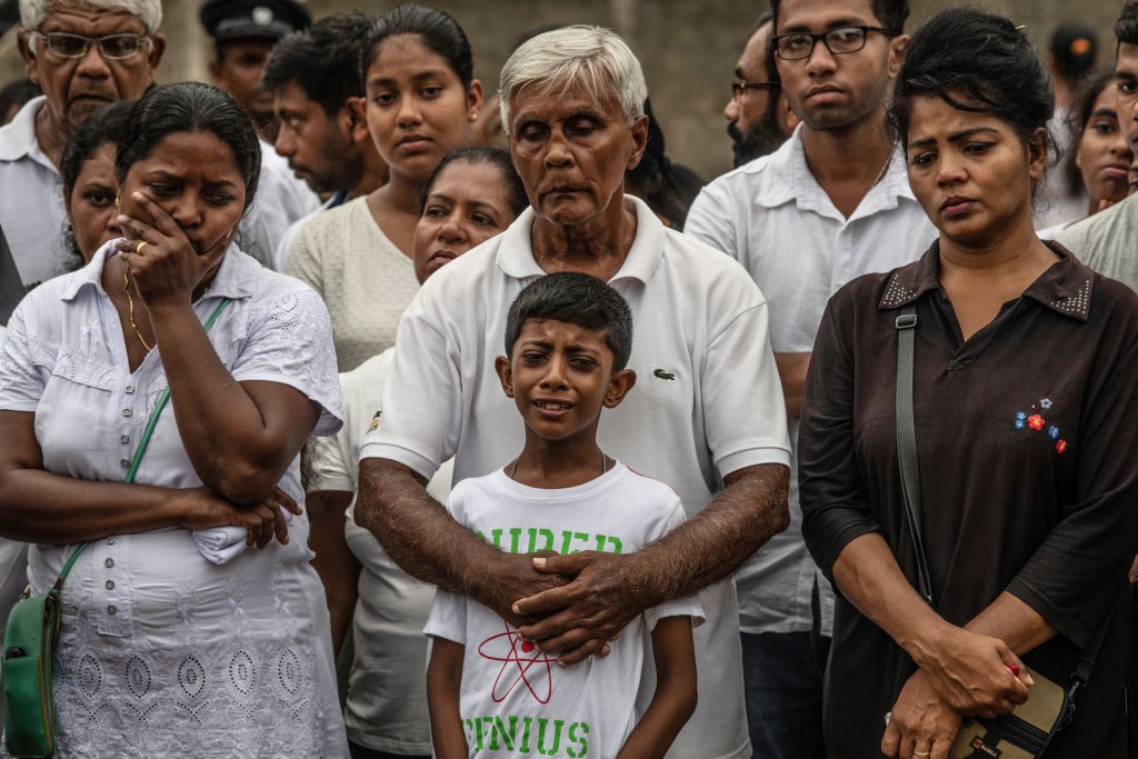 NEGOMBO, SRI LANKA - APRIL 25: A young boy cries during a funeral for a family member killed in the Easter Sunday attack on St Sebastian's Church, on April 25, 2019 in Negombo, Sri Lanka. At least 359 people were killed and 500 people injured after coordinated attacks on churches and hotels on Easter Sunday which rocked three churches and three luxury hotels in and around Colombo as well as at Batticaloa in Sri Lanka. According to reports, police have identified eight out of nine attackers on Wednesday as the Islamic State group have claimed responsibility for the attacks. Police have detained 60 suspects so far in connection with the suicide bombs while the country's government blame the attacks on local Islamist group National Thowheed Jamath (NTJ). (Photo by Carl Court/Getty Images)