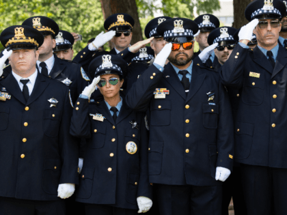 Members of the Chicago Police Department salute during the 38th Annual National Peace Offi