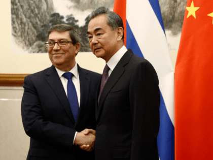 Cuban Foreign Minister Bruno Rodriguez and Chinese Foreign Minister Wang Yi shake hands at