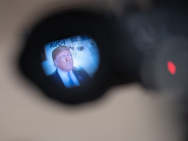 TOPSHOT - As seen through a television camera, US President Donald Trump speaks about the