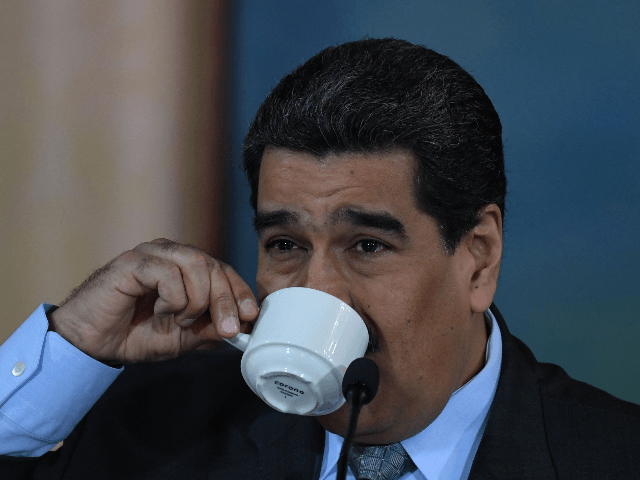 Venezuelan President Nicolas Maduro drinks coffee during a press conference in Caracas on September 30, 2019. - Virtually all countries sent diplomats to the United Nations for the General Assembly last week, but Venezuela was a special case -- it had two delegations, each dueling for recognition. (Photo by YURI …