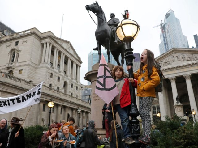 Activists protest outside the Bank of England (L) during the eighth day of demonstrations