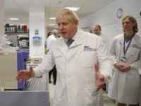 CAMBRIDGE, ENGLAND - OCTOBER 31: British Prime Minister Boris Johnson gestures as he speaks to Dr Sarah Bowdin during a visit to the East Midlands and East of England Genomic Laboratory Hub at Addenbrooke's Hospital on October 31, 2019 in Cambridge, England. (Photo by Alastair Grant - WPA Pool/Getty Images)