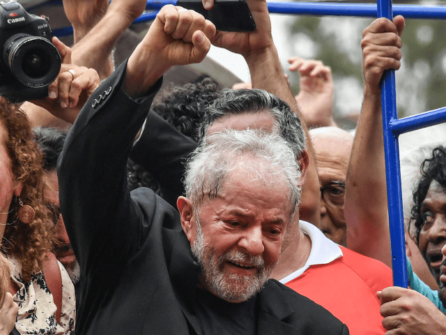 Brazilian former president (2003-2011) Luiz Inacio Lula da Silva raises his fist during a