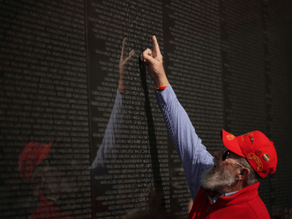 A veteran points to a name on the Vietnam War Memorial on Veterans Day on November 11, 2019 in Washington, DC. (Photo by MANDEL NGAN / AFP) (Photo by MANDEL NGAN/AFP via Getty Images)