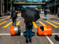 Pro-democracy protesters block a road during a demonstration in Central in Hong Kong on November 15, 2019. - Thousands of pro-democracy protesters took to Hong Kong's streets, defying a warning by Chinese President Xi Jinping, as a campaign of mass disruption extended into a fifth straight day. (Photo by ISAAC …