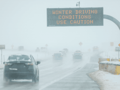 Drivers make their way along slick and snowy roads on November 26, 2019 in Denver, Colorado. A strong winter storm dropped nearly a foot of snow on the city. (Photo by Joe Mahoney/Getty Images)