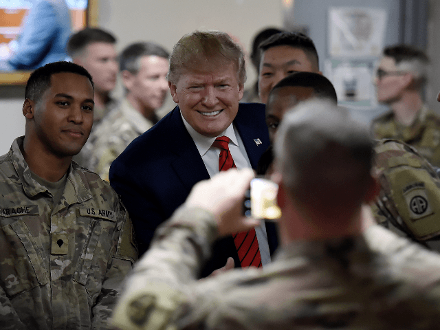 US President Donald Trump serves Thanksgiving dinner to US troops at Bagram Air Field during a surprise visit on November 28, 2019 in Afghanistan. (Photo by Olivier Douliery / AFP) (Photo by OLIVIER DOULIERY/AFP via Getty Images)