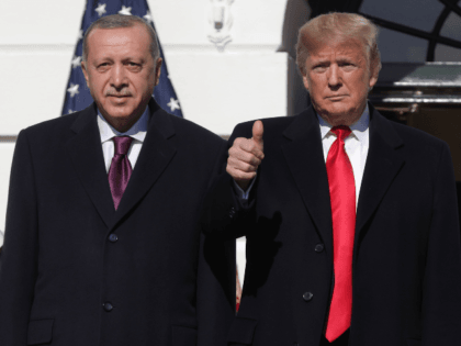 U.S. President Donald Trump (R) gives a thumbs up will greeting Turkish President Recep Ta