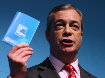 LONDON, ENGLAND - NOVEMBER 22: Brexit Party leader Nigel Farage holds up his 'contract with the people' as he launches the Brexit Party's general election policies at Millbank Tower on November 22, 2019 in London, England. The party leader announced that he wants 'a political revoltion that puts the ordinary …