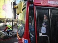 LONDON, ENGLAND - FEBRUARY 05: A commuter stands on a packed bus at Waterloo station on February 5, 2014, in London, England. Today marks the first full day of a 48 hour strike by London underground workers. Workers on London's Underground train system began strike action at 9:00 pm on …