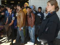 SCHOENEFELD, GERMANY - SEPTEMBER 24: Migrants prepare to board buses that will take them to shelters after they disembarked from a government-chartered train that brought them from Bavaria on September 24, 2015 near Berlin in Schoenefeld, Germany. Germany is continuing to accept throusands of new migrants daily, many of them …