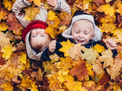 Children Enjoy in Autumn Leaves. Autumn Games.