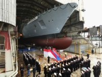 HAMBURG, GERMANY - MARCH 04: A marching band of the Bundeswehr, the German armed forces, plays during the christening ceremony of the "Sachsen-Anhalt" military frigate at the Blohm+Voss shipyard on March 4, 2016 in Hamburg, Germany. The "Sachsen-Anhalt" is the third of a total of four F125-class frigates the Germany …