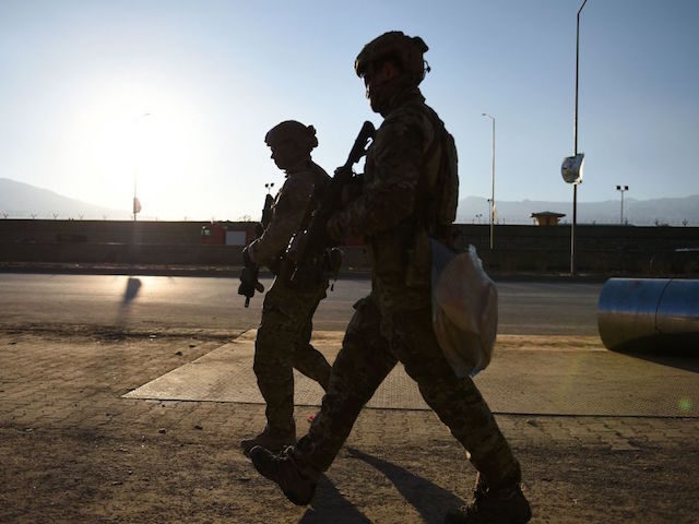US soldiers arrive at the site of a suicide car bombing that targeted an Afghan police dis