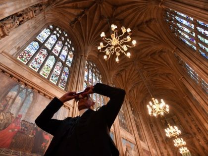 Serjeant-at-Arms of the House of Commons, Kamal El-Hajji, uses a headset to take a 360 degree virtual tour of St Stephen's Hall, as he stands inside the hall at the Houses of Parliament in central London on March 15, 2017, during a photocall to promote the launch of the online …