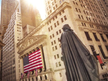 Famous Wall street and the building in New York, New York Stock Exchange with patriot flag