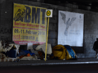 People walk past tents at a makeshift homeless encampment under a bridge on March 1, 2018 in Berlin's Tiergarten district. Fresh heavy snowfalls and icy blizzards were expected to lash Europe on March 1, 2018 as the region shivers in a deadly deep-freeze that has gripped countries from the far …