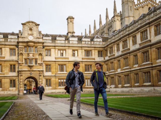 Students walk through Cambridge University in Cambridge, east of England, on March 14, 2018. / AFP PHOTO / Tolga Akmen (Photo credit should read TOLGA AKMEN/AFP via Getty Images)