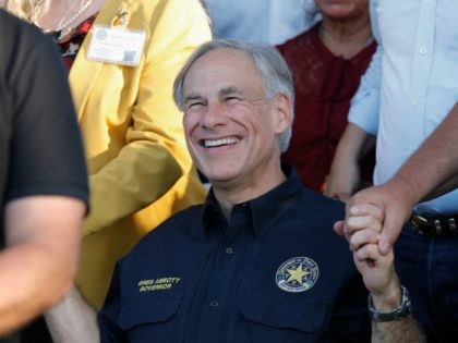 SANTA FE, TX - MAY 18: Texas Governor Greg Abbott holds hands with family and friends at a vigil held at the First Bank in Santa Fe for the victims of a shooting incident at Santa Fe High School where a shooter killed at least 10 students on May 18, …