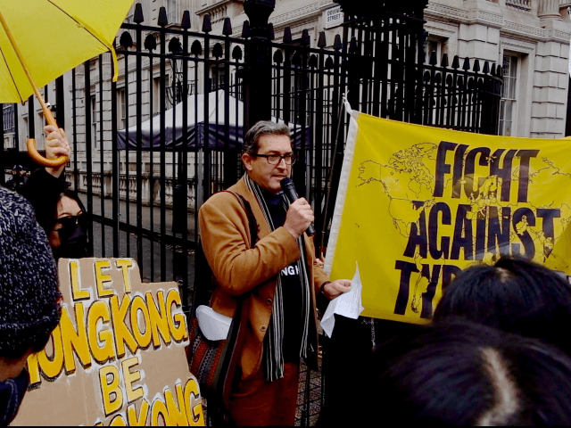 Benedict Rogers founder of the UK based NGO, Hong Kong Watch, outside of the gates of 10 D