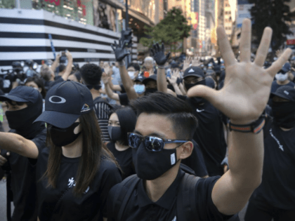 Demonstrators wearing masks gather during an anti-government protest in Hong Kong, Saturda