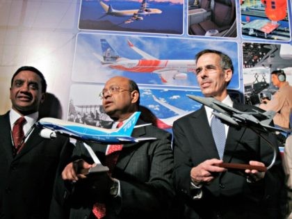 The Boeing Company Chief Technology Officer and Senior Vice President of Engineering, Operations and Technology John J. Tracy, right, and Boeing India President Dinesh A. Keskar, center, hold miniatures of the company's aircraft, as Boeing India Vice President Engineering and Technology Naveed Hussain looks on during the launch of the …