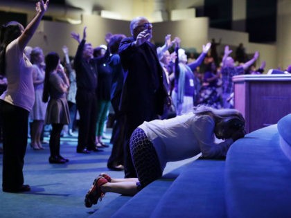 Worshippers pray during a service at the International Church of Las Vegas before the arrival of Republican presidential nominee Donald Trump October 30, 2016 in Las Vegas, Nevada. With nine days to go before Election Day, Trump is hoping to inspire the GOP base, including evangelical Christians, to support him. …