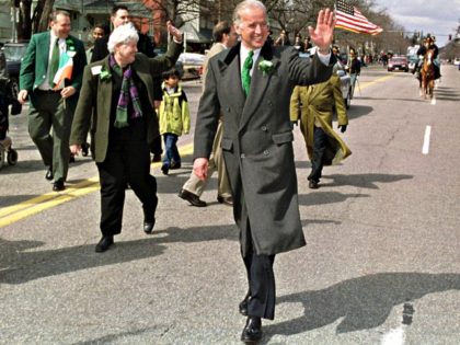 Sen. Joseph Biden, D-Del., center, waves to spectators along the parade route for the St. Patrick's Day Parade in Manchester, N.H., Sunday, March 25, 2001. (AP Photo/Lee Marriner)