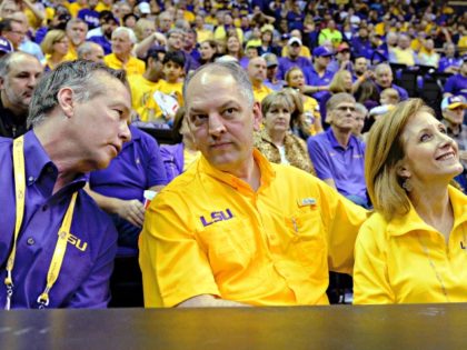 LSU president F. King Alexander, left, chats with Louisiana Gov. John Bel Edwards, center, and Edwards' wife, Donna, during the first half of an NCAA college basketball game between Oklahoma and LSU in Baton Rouge, La., Saturday, Jan. 30, 2016. Oklahoma won 77-75. (AP Photo/Bill Feig)