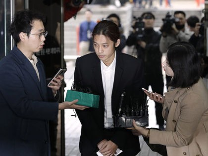 K-pop singer Jung Joon-young is questioned by reporters upon his arrival to attend a hearing at the Seoul Central District Court in Seoul, South Korea, Thursday, March 21, 2019. A South Korean pop star has appeared at a court hearing to decide whether to arrest him over allegations that he …