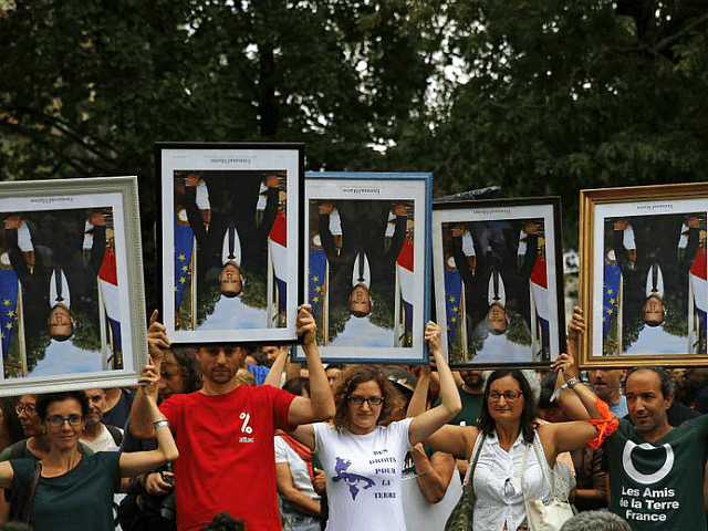 FILE - In this Aug.25, 2019 file photo, demonstrators hold up upside down portraits of Fre