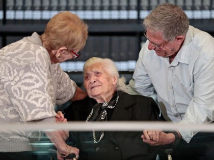 Greek World War II rescuer Melpomeni Dina (C) reacts as she is reunited with holocaust survivors Yossi Mor (R) and his sister Sarah Yanai, whom she helped escape in 1943, at the Hall of Names at the Yad Vashem Holocaust Memorial museum in Jerusalem on November 3, 2019. (Photo by …