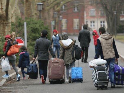 BERLIN, GERMANY - MARCH 11: People pulling suitcases arrive at the Central Registration Office for Asylum Seekers (Zentrale Aufnahmestelle fuer Fluechtlinge, or ZAA) of the State Office for Health and Social Services (Landesamt fuer Gesundheit und Soziales, or LAGeSo), which is the registration office for refugees and migrants arriving in …