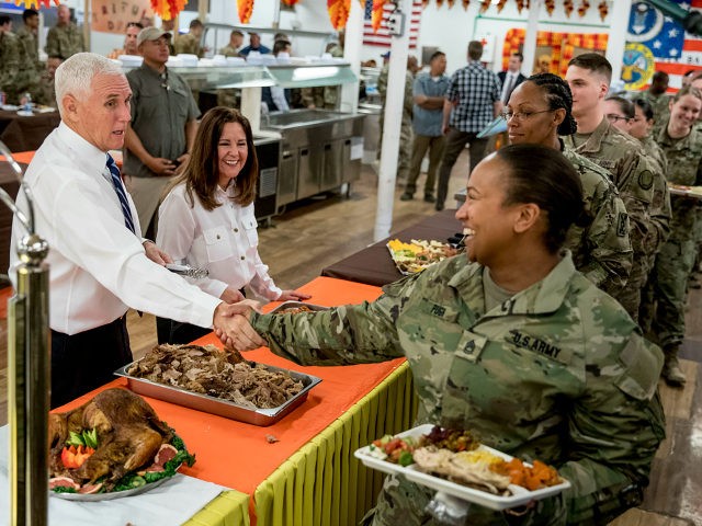 Vice President Mike Pence and his wife Karen Pence, second from left, serve turkey to troops at Al Asad Air Base, Iraq, Saturday, Nov. 23, 2019. The visit is Pence’s first to Iraq and comes nearly one year since President Donald Trump’s surprise visit to the country. (AP Photo/Andrew Harnik)