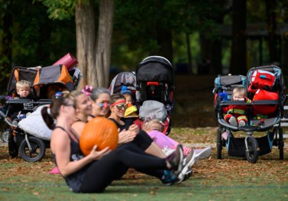Children watch their mothers pass a pumpkin during a Halloween themed boot camp style workout, Stroller Strong Moms, geared towards moms in Arlington, Virginia on October 25, 2019. (Photo by Andrew CABALLERO-REYNOLDS / AFP) (Photo by ANDREW CABALLERO-REYNOLDS/AFP via Getty Images)