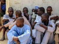 Men gather during a burial ceremony, after two people were killed by Boko Haram fighters in Dalori camp for internally displaced people, near Maiduguri, on July 26, 2019. - Two people were killed and several wounded when Boko Haram fighters raided a camp for people displaced by the jihadist conflict …