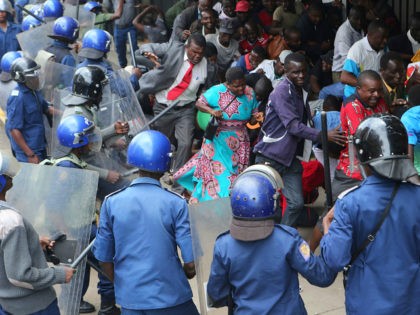 Police surround opposition party supporters who had gathered to hear a speech by the country's top opposition leader in Harare, Wednesday, Nov. 20, 2019. Zimbabwean police with riot gear fired tear gas and struck people who had gathered at the opposition party headquarters to hear a speech by the main …