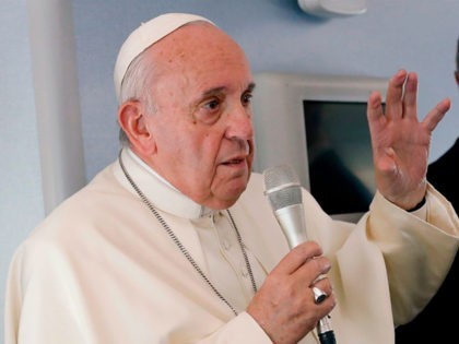 Pope Francis speaks to reporters during a news conference onboard the papal plane on his f