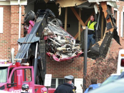 Porsche is removed form the second story of a building after the convertible went airborne