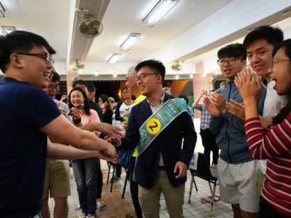 Pro-democracy candidate James Yu, center, celebrates with supporters after winning his seat in district council elections in Hong Kong, early Monday, Nov. 25, 2019. Vote counting was underway in Hong Kong on Sunday after a massive turnout in district council elections seen as a barometer of public support for pro-democracy …