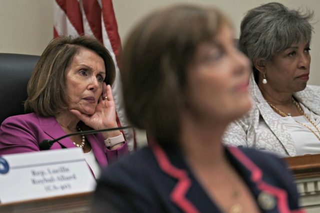 WASHINGTON, DC - JUNE 21: U.S. House Minority Leader Rep. Nancy Pelosi (D-CA) (L) and Rep. Brenda Lawrence (D-MI) (R) listen during a "shadow hearing" before the Democratic Women's Working Group (DWWG) June 21, 2018 on Capitol Hill in Washington, DC. The hearing addressed immigration and family separation at the …