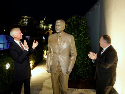 Together with United States Ambassador in Germany Richard Grenell, right, and Fred Ryan Board Chairman of the Reagan Foundation, left, Secretary of State Mike Pompeo unveils a statue of former President Ronald Reagan on the top of United States embassy in Berlin, Germany, Friday, Nov. 7, 2019. AP Photo/Markus Schreiber)