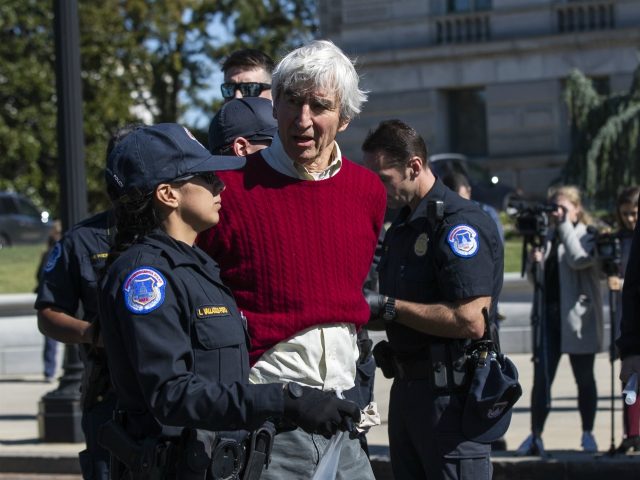 Actor Sam Waterston is arrested by U.S. Capitol Police officers during a rally on Capitol