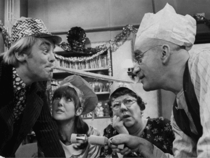 30th November 1966: Alf Garnett, played by Warren Mitchell, and his son-in-law Mike, played by Anthony Booth, arguing over the Christmas dinner table in a scene from the popular BBC comedy series 'Till Death Do Us Part'. From left to right, Anthony Booth, Una Stubbs, Dandy Nichols and Warren Mitchell. …