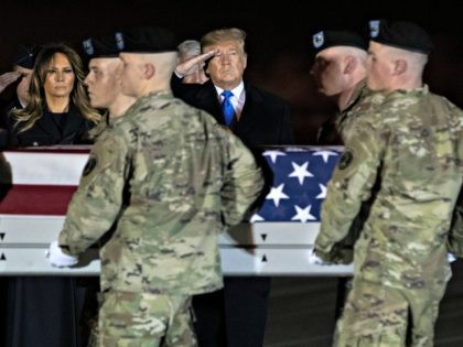 President Donald Trump and first lady Melania Trump look on as a U.S. Army carry team moves a transfer case containing the remains of Chief Warrant Officer 2 David C. Knadle, of Tarrant, Texas, who according to the Department of Defense died in Afghanistan, during a casualty return ceremony, Thursday, …