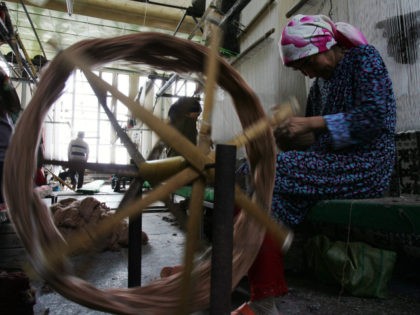 Uigur women weave carpets in the Hetian Carpet Factory on September 4, 2007 in Hetian of Xinjiang Uygur Autonomous Region, China. Hetian, nicknamed in China as "Carpet Country," has a 3,000 year history of carpet weaving. Xinjiang has been noted in ancient times along the old silk road as a …