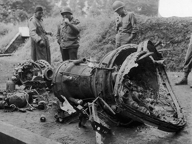 Soldiers examine the wreckage of a German V-2 rocket bomb which fell in Belgium and was no